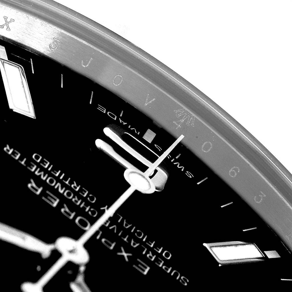Close-up angle of a Rolex Explorer 214270 Men's Stainless Steel Black Dial 214270 Men's Stainless Steel Black Dial watch showing part of the dial and bezel with markings.