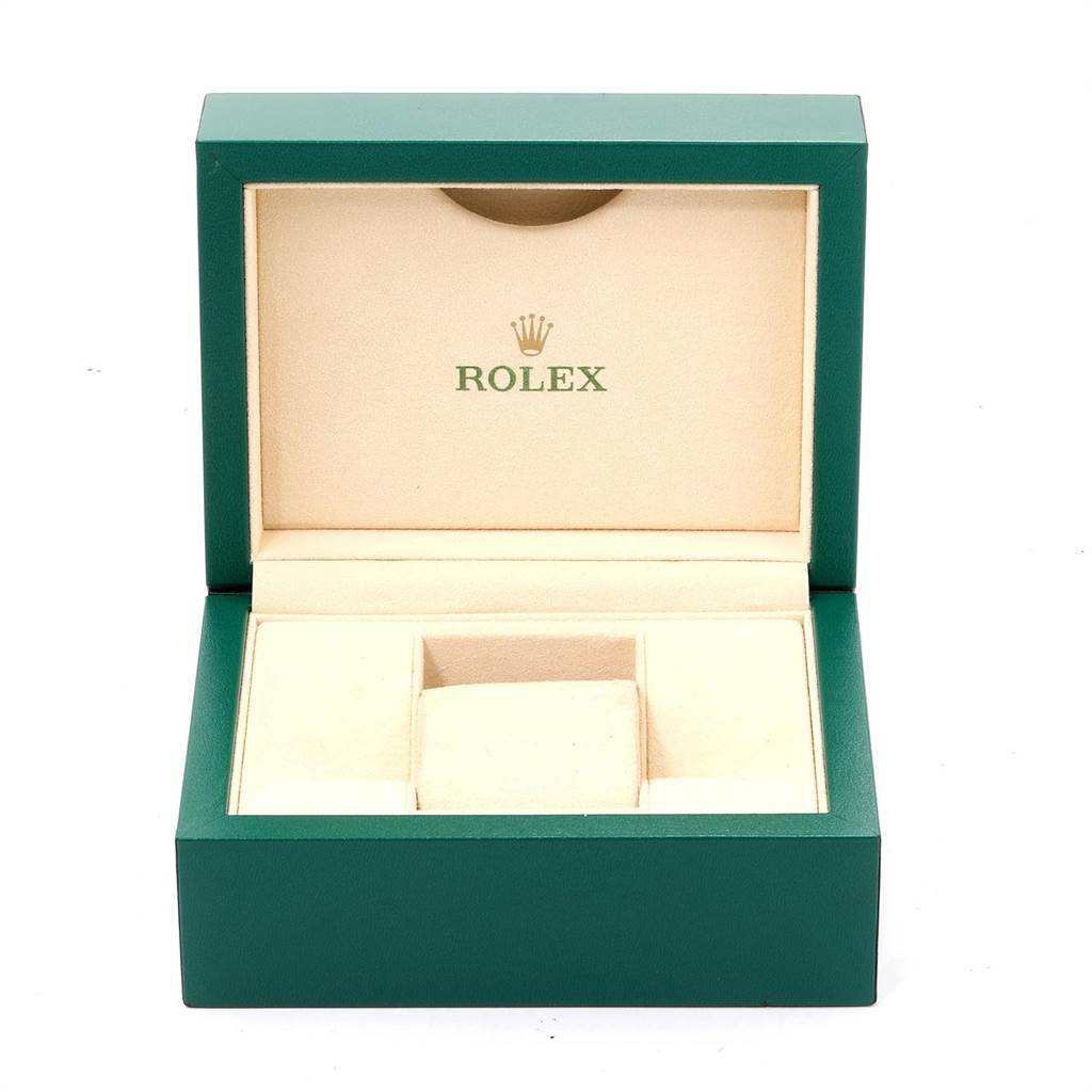 This image shows an open green and beige Rolex box for the Explorer model, displaying the interior compartments.