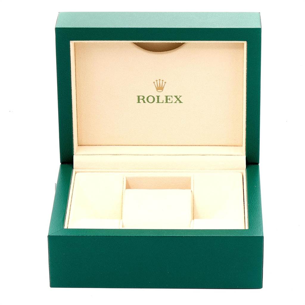 The image shows an open green and beige Rolex box for the Explorer model.