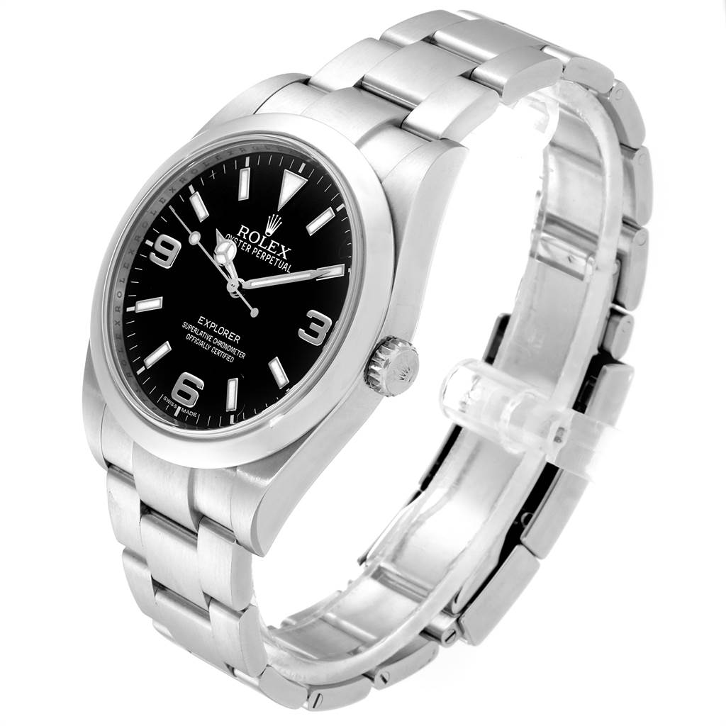 The Rolex Explorer 214270 Men's Stainless Steel Black Dial 214270 Men's Stainless Steel Black Dial watch is shown at a three-quarter angle, highlighting its face, bezel, crown, and metal bracelet.