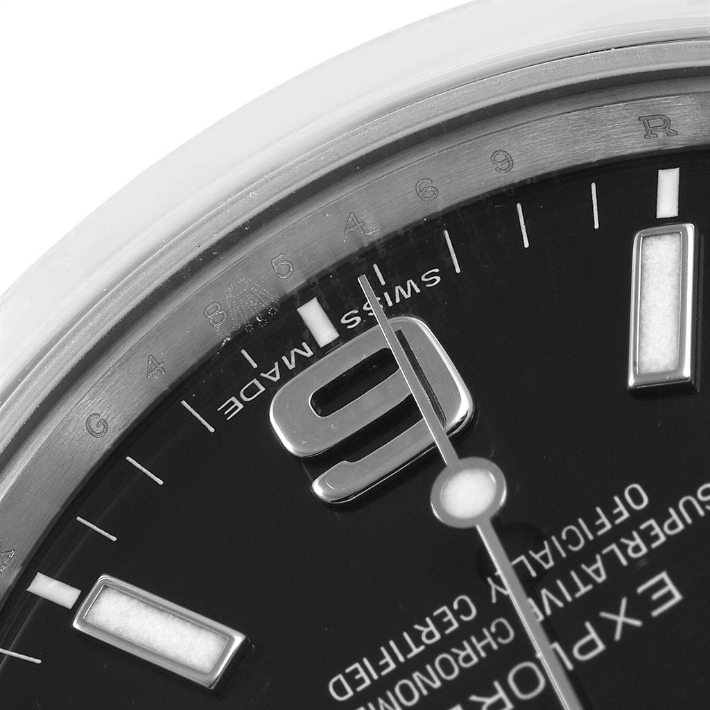 This close-up of the Rolex Explorer 214270 Men's Stainless Steel Black Dial 214270 Men's Stainless Steel Black Dial model shows the watch face with the number 9, hour markers, and part of the hands.