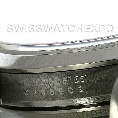 This close-up image shows the side of a Rolex Explorer 114270 Men's Stainless Steel Black Dial 114270 Men's Stainless Steel Black Dial watch, focusing on the serial number and "STAINLESS STEEL" engraving.