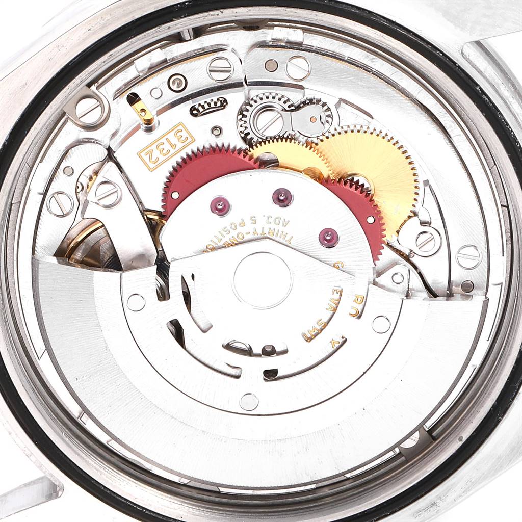This image shows a close-up of the internal mechanism of a Rolex Explorer 214270 Men's Stainless Steel Black Dial 214270 Men's Stainless Steel Black Dial watch, highlighting its gears and movement components.
