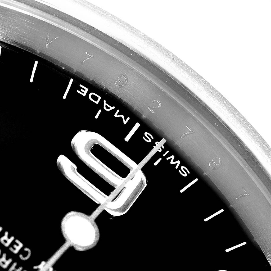 The close-up image shows a segment of the Rolex Explorer 114270 Men's Stainless Steel Black Dial 114270 Men's Stainless Steel Black Dial watch face, highlighting the "9" numeral and the "Swiss Made" text.