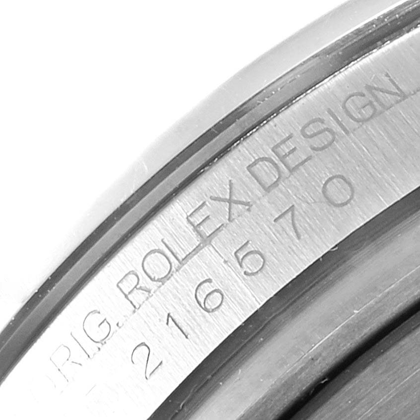 This close-up image shows the engraved model number 216570 and "ROLEX DESIGN" on the caseback of a Rolex Explorer 216570 Men's Stainless Steel White Dial 216570 Men's Stainless Steel White Dial watch.