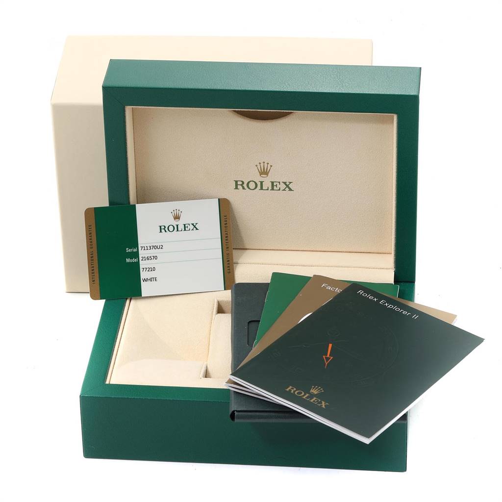 The image shows the packaging for a Rolex Explorer 216570 Men's Stainless Steel White Dial 216570 Men's Stainless Steel White Dial watch, including the box, warranty card, and user manuals.