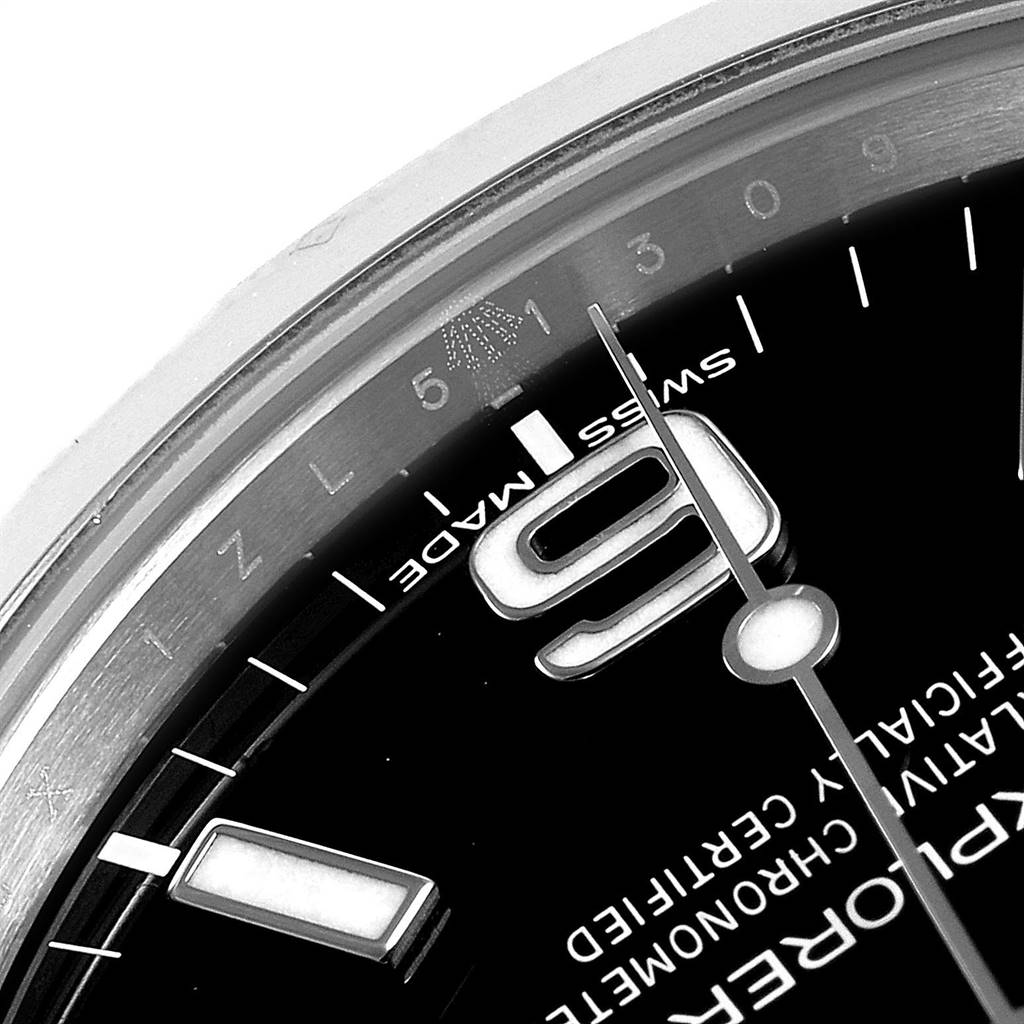 This close-up image of the Rolex Explorer 214270 Men's Stainless Steel Black Dial 214270 Men's Stainless Steel Black Dial watch shows the 3, 6, and 9 numerals along with part of the dial and “Swiss Made” inscription.