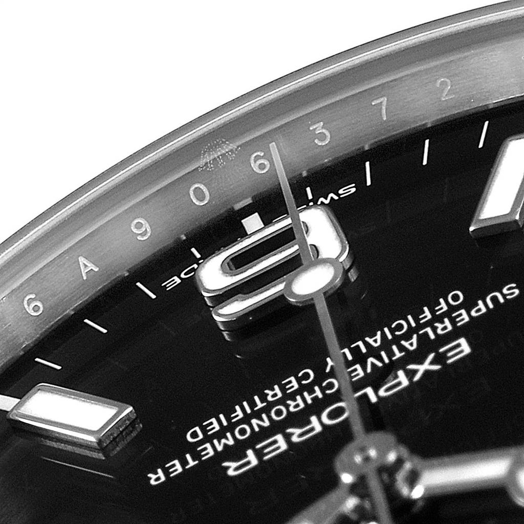 This close-up image shows the dial, hands, and part of the index markers on the Rolex Explorer 214270 Men's Stainless Steel Black Dial 214270 Men's Stainless Steel Black Dial watch.