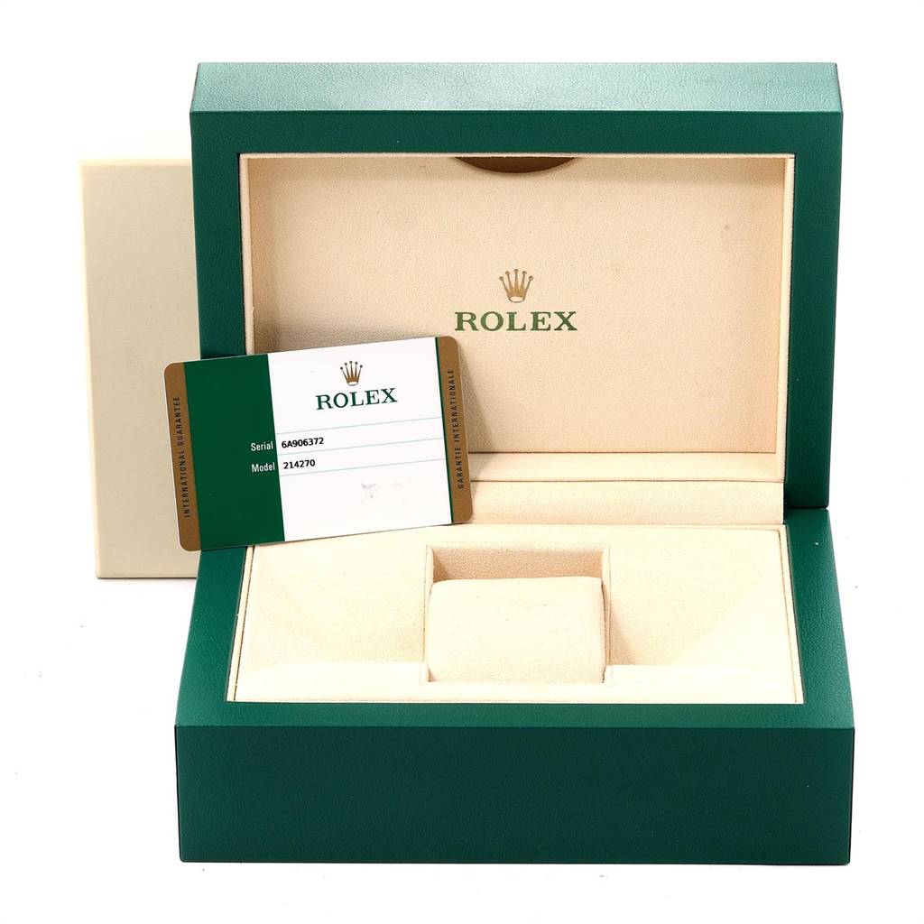 The image shows an open Rolex Explorer 214270 Men's Stainless Steel Black Dial 214270 Men's Stainless Steel Black Dial watch box with the watch absent, displaying the interior and a warranty card.