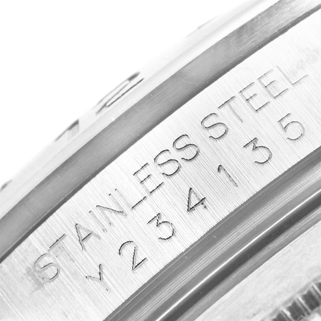 This close-up angle shows the engraved "STAINLESS STEEL" text and serial number on the side of a Rolex Explorer 16570 Men's Stainless Steel White Dial 16570 Men's Stainless Steel White Dial watch.