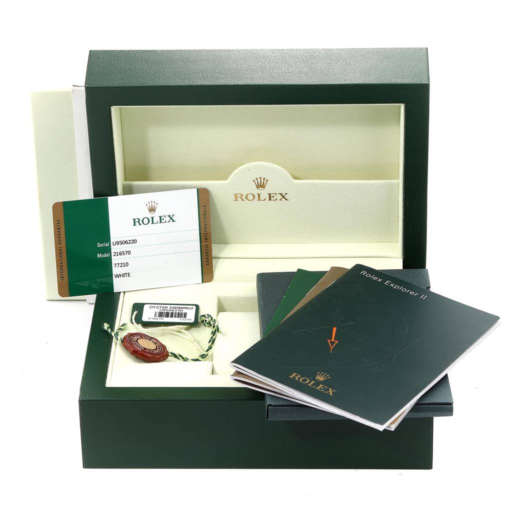 The image shows the packaging and accessories for a Rolex Explorer 216570 Men's Stainless Steel White Dial 216570 Men's Stainless Steel White Dial model, including the box, manuals, and authenticity card.