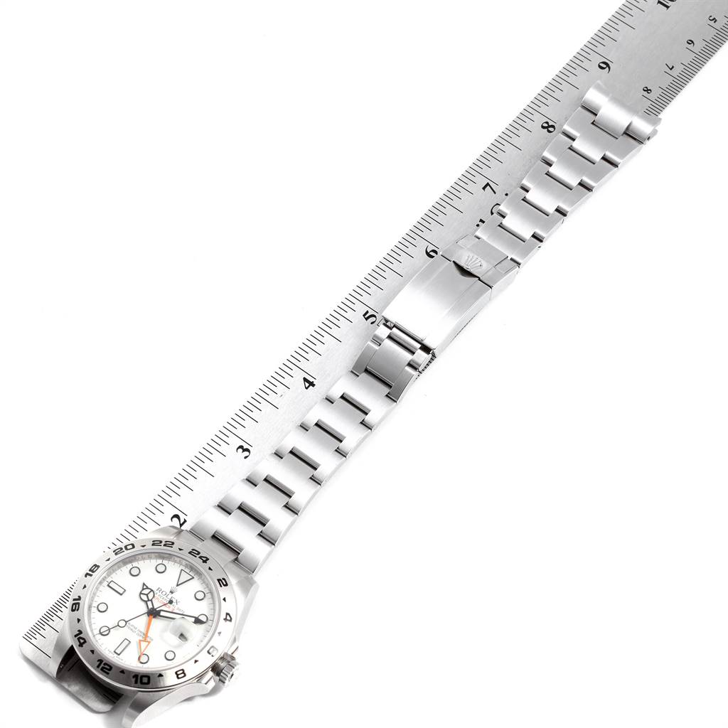 The image shows a top-down view of a Rolex Explorer 216570 Men's Stainless Steel White Dial 216570 Men's Stainless Steel White Dial watch measuring its band length with a ruler.