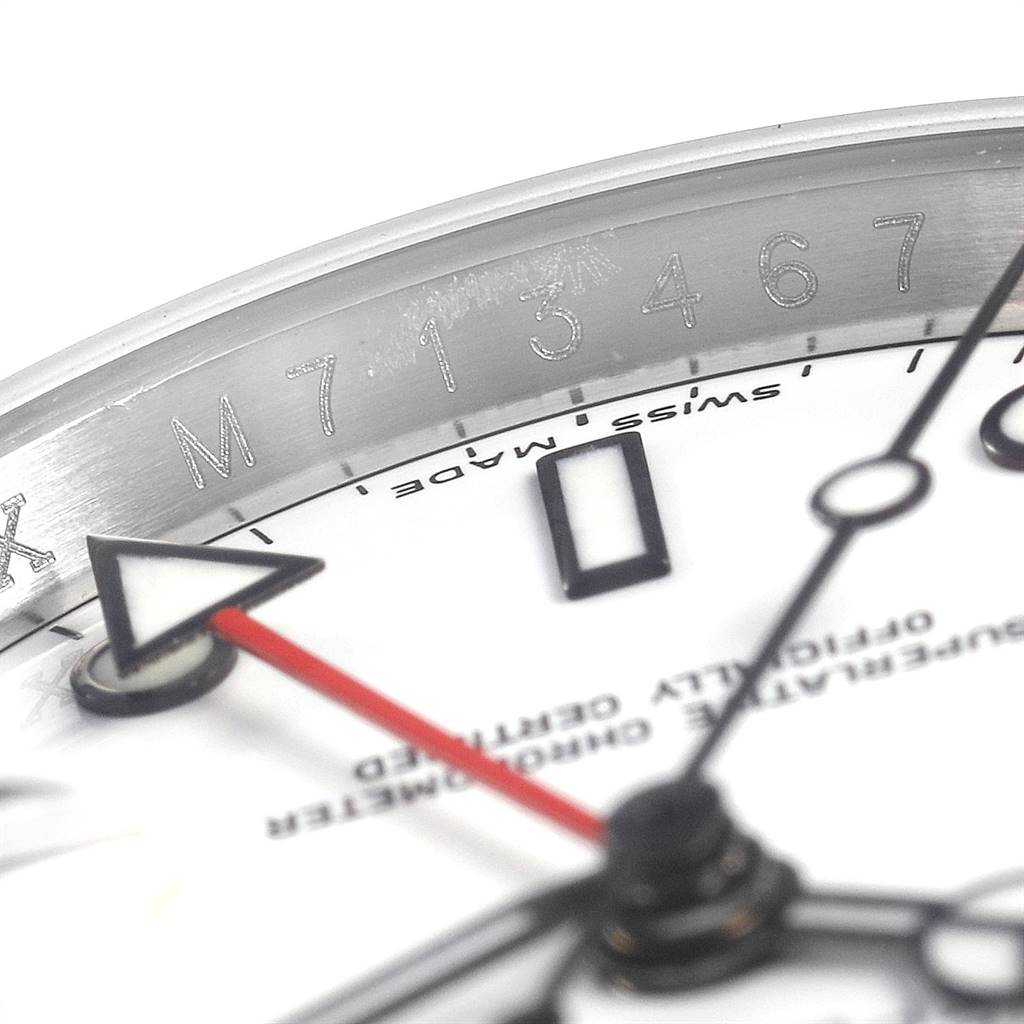 The image shows a close-up of the Rolex Explorer 16570 Men's Stainless Steel White Dial 16570 Men's Stainless Steel White Dial model watch, detailing the serial number, red second hand, and part of the dial.