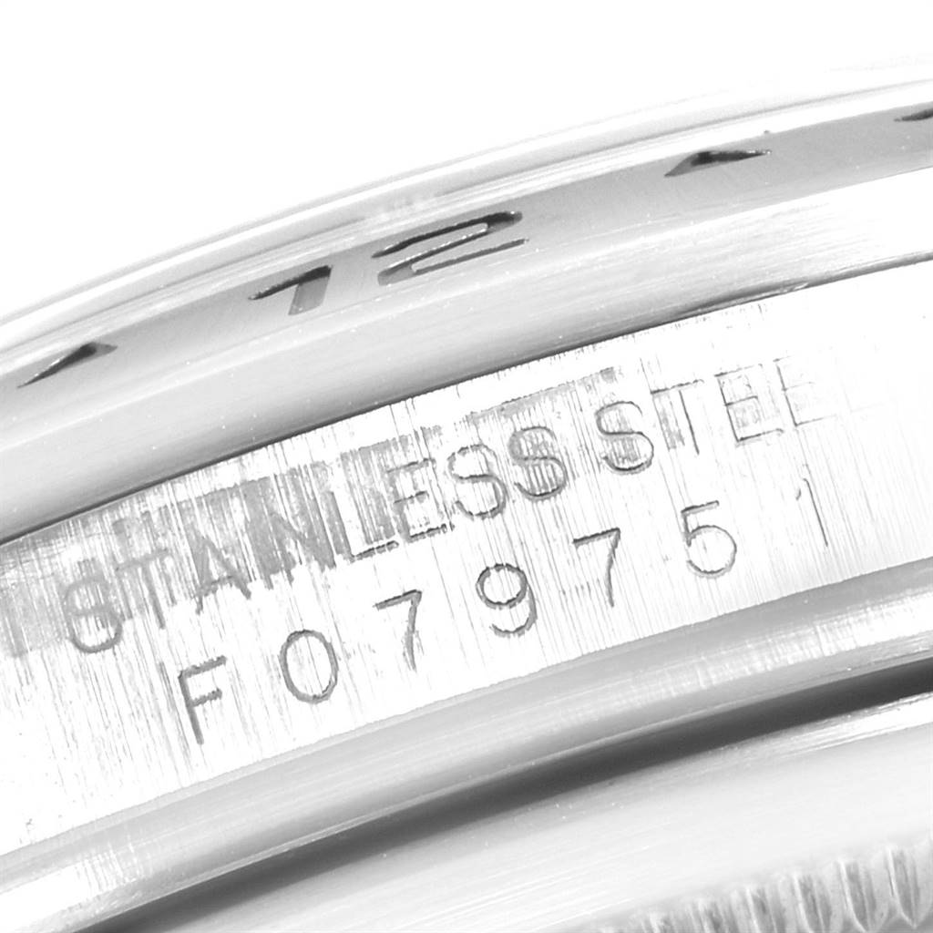 This close-up image shows the side engraving on the stainless steel case of a Rolex Explorer 16570 Men's Stainless Steel White Dial 16570 Men's Stainless Steel White Dial watch.