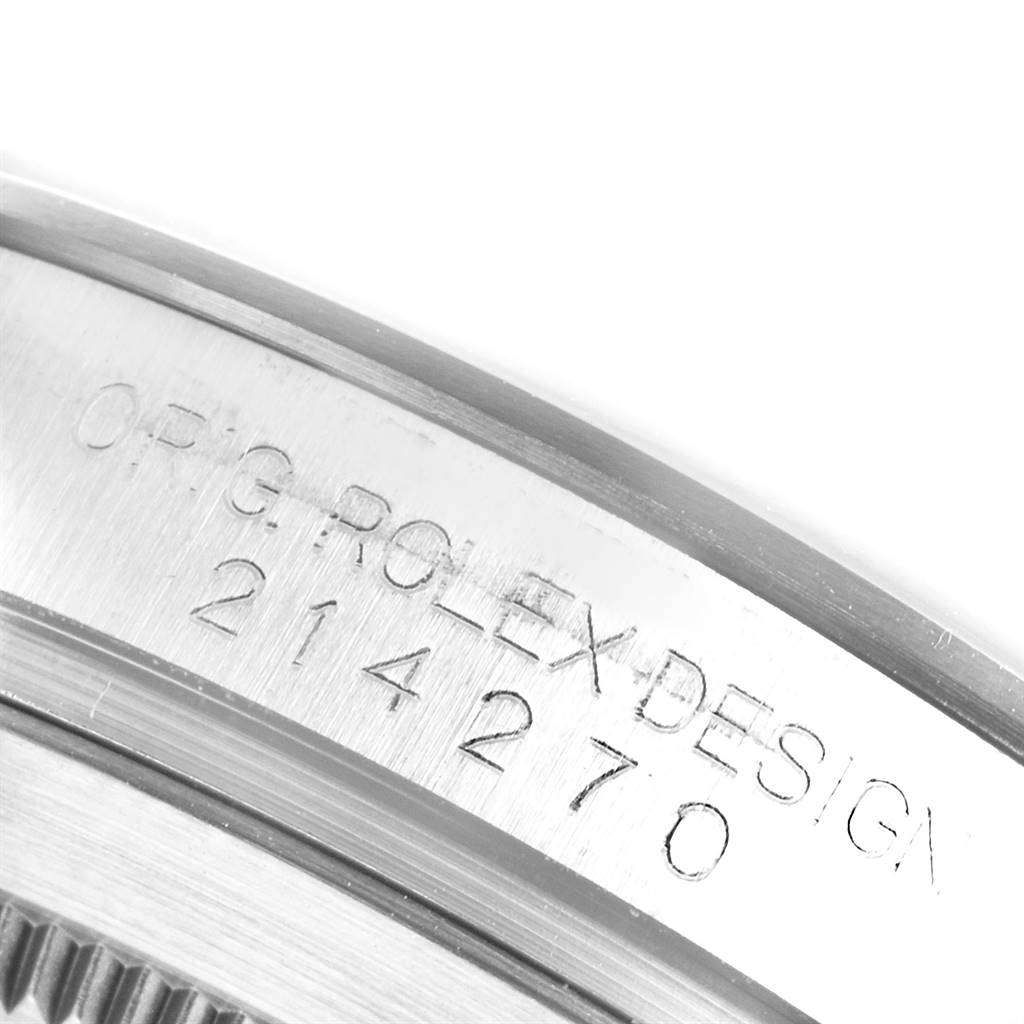 This is a macro shot of the case of a Rolex Explorer 214270 Men's Stainless Steel Black Dial 214270 Men's Stainless Steel Black Dial showing the "ORIG. ROLEX DESIGN 214270" engraving.