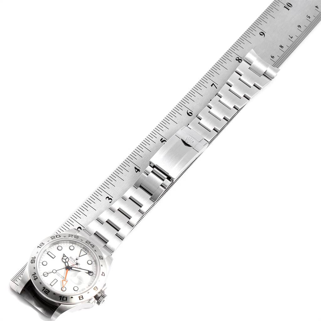 The image shows a Rolex Explorer 216570 Men's Stainless Steel White Dial 216570 Men's Stainless Steel White Dial watch with a ruler displaying its bracelet length and clasp from a top-down angle.