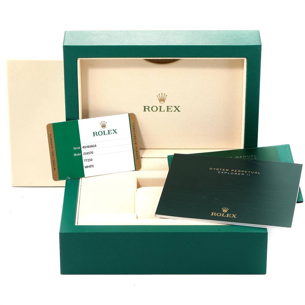 This image shows the packaging and accessories for a Rolex Explorer 216570 Men's Stainless Steel White Dial 216570 Men's Stainless Steel White Dial model, including the box, manuals, and guarantee card.