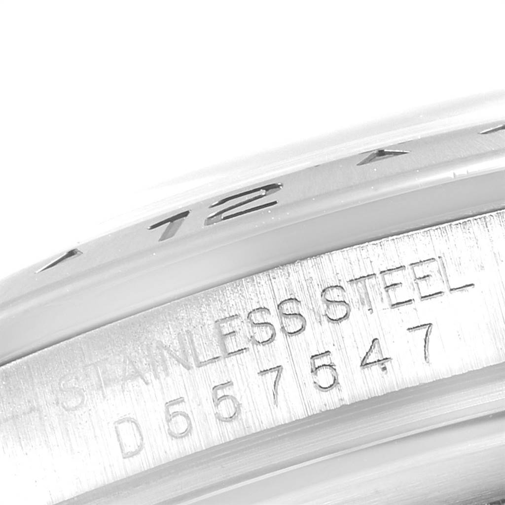 This image shows a close-up of the serial number and "STAINLESS STEEL" engraving on the side of a Rolex Explorer 16570 Men's Stainless Steel Black Dial 16570 Men's Stainless Steel Black Dial watch case.