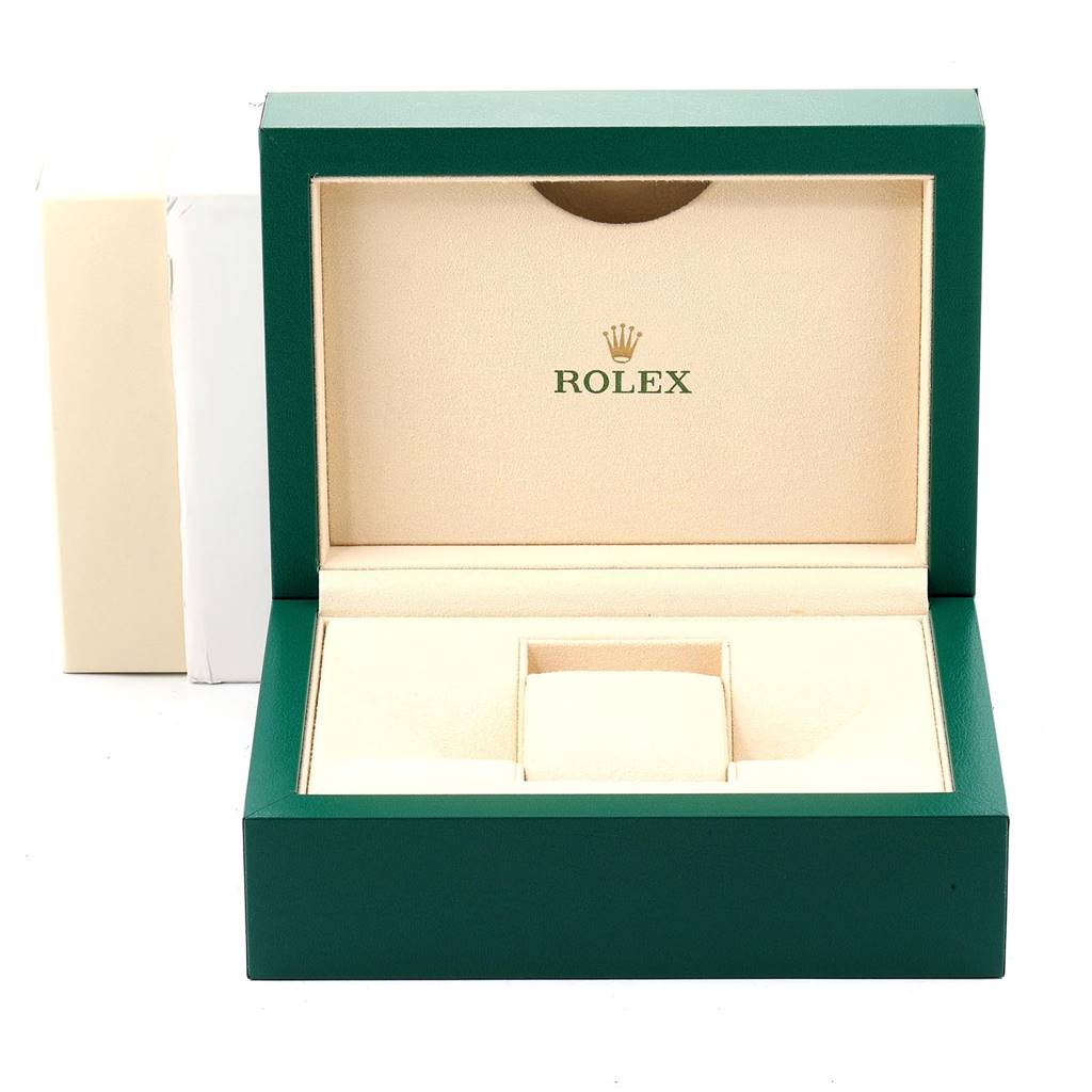 The image shows an open green Rolex watch box, likely for an Explorer model, with a beige interior and Rolex logo.