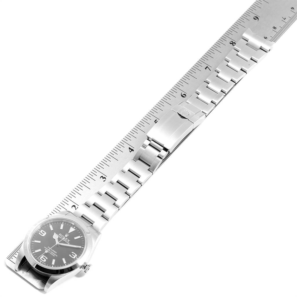 The image shows the Rolex Explorer 214270 Men's Stainless Steel Black Dial 214270 Men's Stainless Steel Black Dial watch laid flat with its strap extended and measured with a ruler.