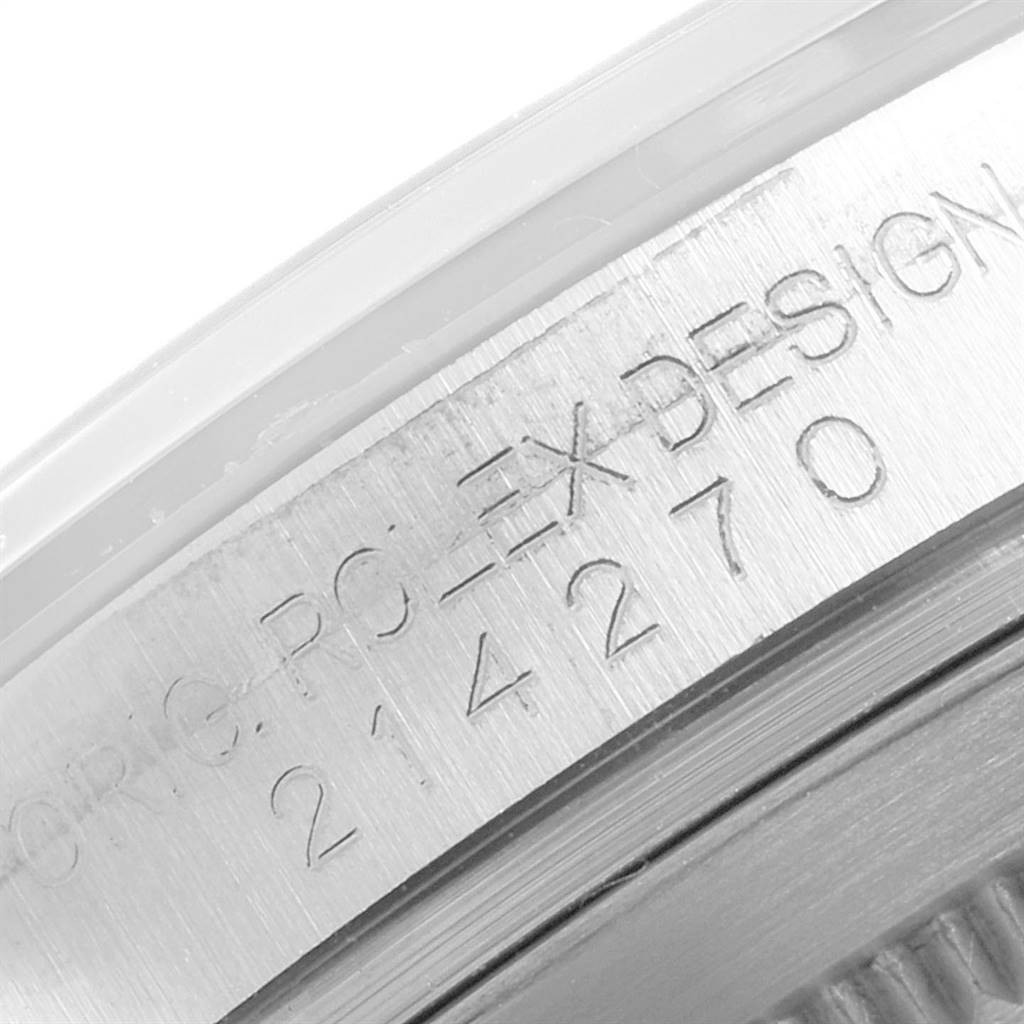 The image shows a close-up of the side bezel of a Rolex Explorer 214270 Men's Stainless Steel Black Dial 214270 Men's Stainless Steel Black Dial watch, displaying the serial and model number engravings.