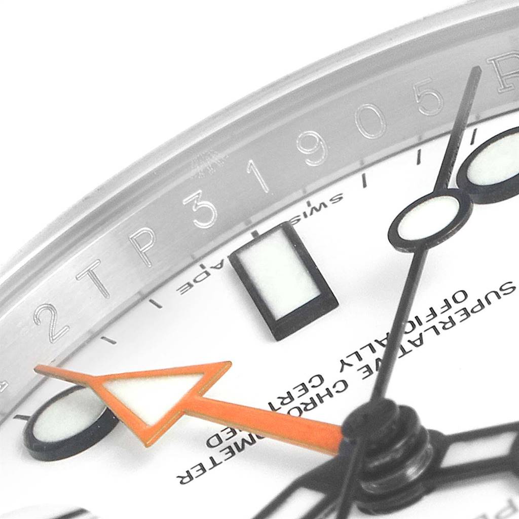 Close-up of the dial and bezel of a Rolex Explorer 216570 Men's Stainless Steel White Dial 216570 Men's Stainless Steel White Dial, showing the hour markers, hands, and engraved numbers.