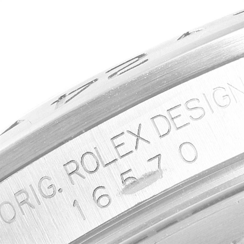 This close-up image shows the engraved text on the case of a Rolex Explorer 16570 Men's Stainless Steel White Dial 16570 Men's Stainless Steel White Dial watch.