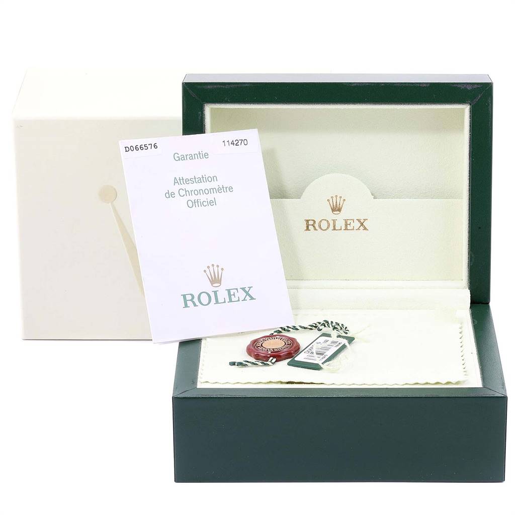 The image shows the packaging, warranty card, and accessories for the Rolex Explorer 114270 Men's Stainless Steel Black Dial 114270 Men's Stainless Steel Black Dial model, including the box and tag.
