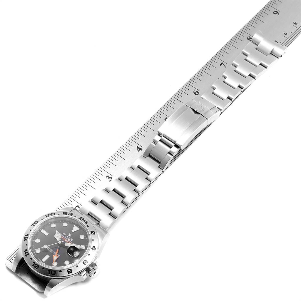 The image shows a Rolex Explorer 216570 Men's Stainless Steel Black Dial 216570 Men's Stainless Steel Black Dial watch with a focus on its stainless steel bracelet, laid alongside a ruler for scale.