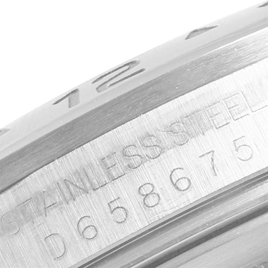 This close-up image shows the serial number and "STAINLESS STEEL" inscription on the case of a Rolex Explorer 16570 Men's Stainless Steel White Dial 16570 Men's Stainless Steel White Dial watch.