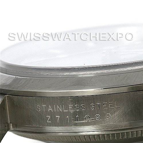 Side view of the stainless steel casing of the Rolex Explorer 114270 Men's Stainless Steel Black Dial 114270 Men's Stainless Steel Black Dial watch, displaying part of the bezel and serial number.