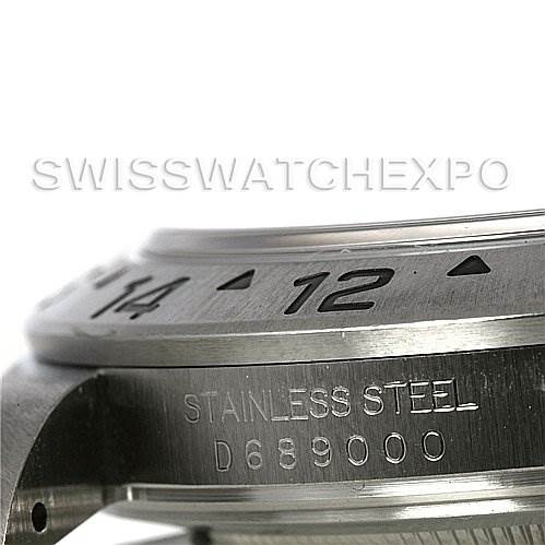 The image shows a close-up, angled view of the bezel and part of the case of a Rolex Explorer 16570 Men's Stainless Steel Black Dial 16570 Men's Stainless Steel Black Dial watch, highlighting the text "STAINLESS STEEL" and serial number.