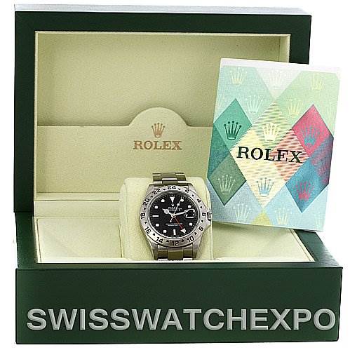 The image shows a Rolex Explorer 16570 Men's Stainless Steel Black Dial 16570 Men's Stainless Steel Black Dial watch in a green opened box with a booklet on the right side.