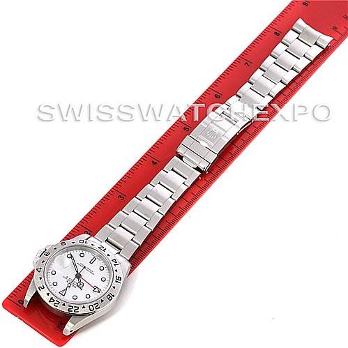 The image shows a top-down view of a Rolex Explorer 16570 Men's Stainless Steel White Dial 16570 Men's Stainless Steel White Dial watch laid out on a red ruler.