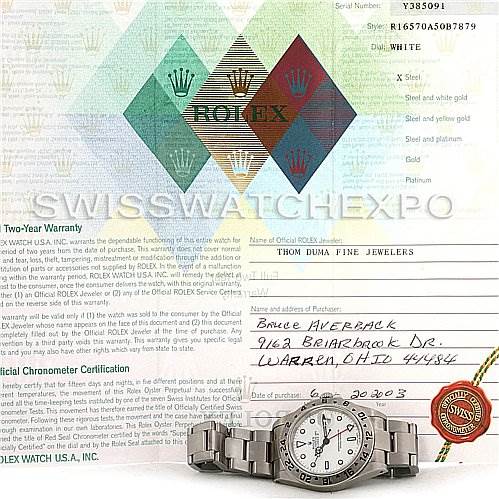 The image shows a Rolex Explorer 16570 Men's Stainless Steel White Dial 16570 Men's Stainless Steel White Dial watch placed on top of warranty documents.