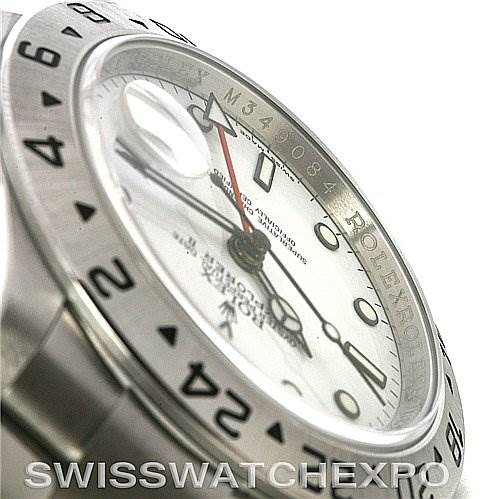 The image shows a close-up of the side of a Rolex Explorer 16570 Men's Stainless Steel White Dial 16570 Men's Stainless Steel White Dial watch, highlighting its bezel, index, and part of the dial.