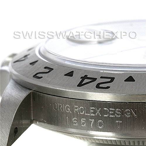 This image shows a side angle of the Rolex Explorer 16570 Men's Stainless Steel White Dial 16570 Men's Stainless Steel White Dial watch model 16570, highlighting the bezel and part of the case with engraved details.