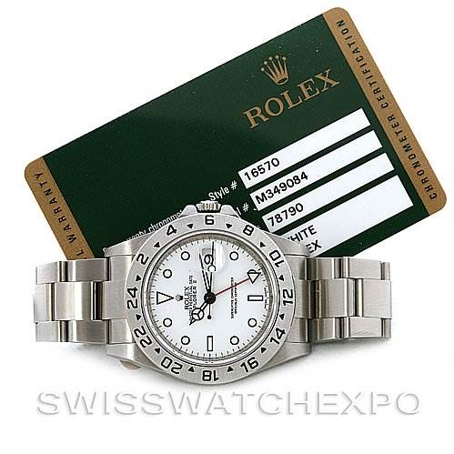 The image shows a Rolex Explorer 16570 Men's Stainless Steel White Dial 16570 Men's Stainless Steel White Dial watch placed flat with its warranty and chronometer certification card in the background.