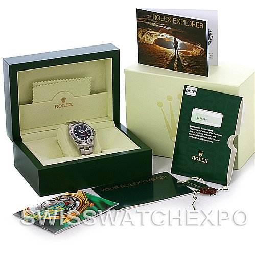 The image shows a Rolex Explorer 16570 Men's Stainless Steel Black Dial 16570 Men's Stainless Steel Black Dial watch in its box along with its accessories, including booklets, a tag, and a cleaning cloth.