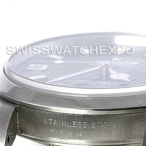 The image shows a side angle of a Rolex Explorer 114270 Men's Stainless Steel Black Dial 114270 Men's Stainless Steel Black Dial watch, highlighting the stainless steel case and serial number engraving.