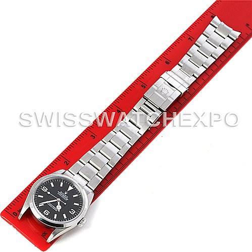 The image shows the full length of a Rolex Explorer 114270 Men's Stainless Steel Black Dial 114270 Men's Stainless Steel Black Dial watch, including the dial, case, and bracelet, measured against a red ruler.