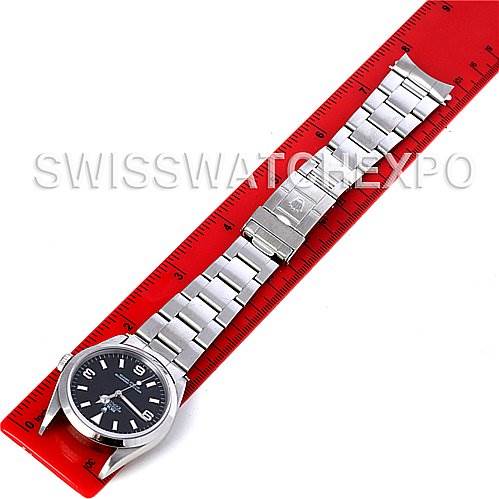 The image shows a Rolex Explorer 14270 Men's Stainless Steel Black Dial 14270 Men's Stainless Steel Black Dial watch laid flat against a red ruler, displaying its face and metal bracelet.
