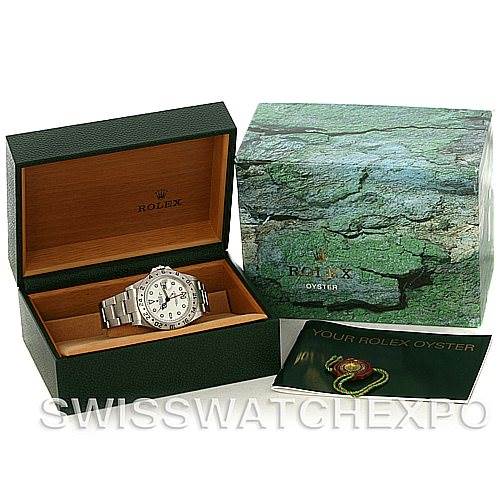 This image shows a Rolex Explorer 16570 Men
s Stainless Steel White Dial 16570 Men
s Stainless Steel White Dial watch, its open box, an outer green box, and a booklet.