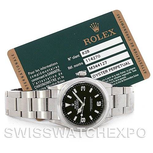 The image shows a Rolex Explorer 114270 Men's Stainless Steel Black Dial 114270 Men's Stainless Steel Black Dial watch with a stainless steel bracelet, viewed from the front along with its certification card.