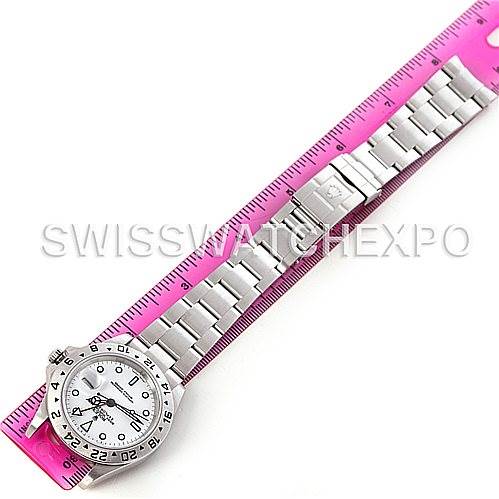 The image shows a top view of a Rolex Explorer 16570 Men's Stainless Steel White Dial 16570 Men's Stainless Steel White Dial watch laid next to a pink ruler, highlighting the band and watch face.