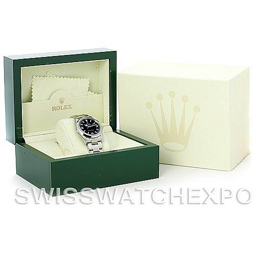 This image shows a Rolex Explorer 114270 Men's Stainless Steel Black Dial 114270 Men's Stainless Steel Black Dial watch in its open green box with a cream-colored cleaning cloth, alongside a closed cream-colored outer box.