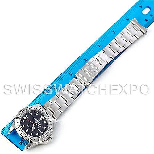 The image shows a top-down view of a Rolex Explorer 16570 Men's Stainless Steel Black Dial 16570 Men's Stainless Steel Black Dial watch, highlighting the face, bezel, and the full metal bracelet alongside a ruler.