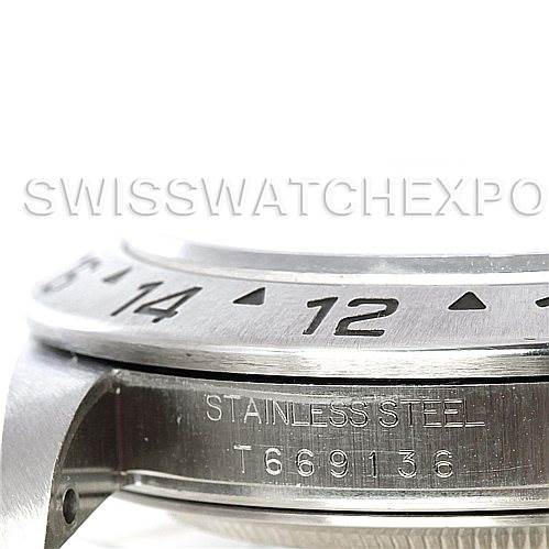The image shows a close-up of the bezel and part of the case of a Rolex Explorer 16570 Men's Stainless Steel Black Dial 16570 Men's Stainless Steel Black Dial model watch, highlighting "Stainless Steel" and a serial number.