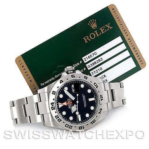 The image shows a Rolex Explorer 216570 Men's Stainless Steel Black Dial 216570 Men's Stainless Steel Black Dial watch with a stainless steel bracelet and a warranty card angled from the front and slightly above.