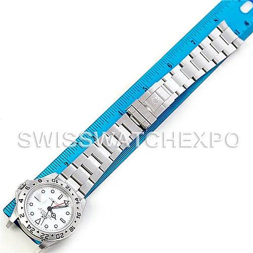 The image shows a Rolex Explorer 16570 Men's Stainless Steel White Dial 16570 Men's Stainless Steel White Dial watch laid flat next to a blue ruler, showcasing the entire front and metal bracelet.